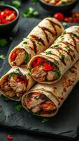 Delicious grilled chicken wraps with fresh vegetables and herbs served on a slate platter at a cozy gathering photo