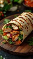 Grilled chicken wrap with fresh vegetables served on a wooden board in a cozy dining setting photo