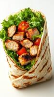 Grilled chicken wrap filled with fresh lettuce and cherry tomatoes served on a white background photo