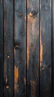 Detailed close-up of weathered black wooden planks with natural texture and warm undertones reflecting light photo