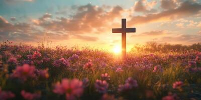 Vibrant sunset over a field of flowers with a solitary cross standing proudly in the foreground photo