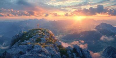 Sunset view from mountain peak with cross overlooking valley and distant mountains in soft light photo