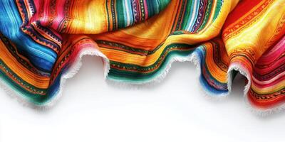 Colorful woven blanket draped elegantly on a clean surface with vibrant patterns and fringes photo