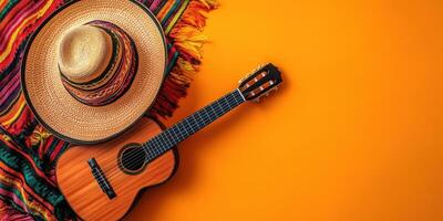 Colorful traditional elements of a festive celebration with a sombrero and guitar on an orange background photo