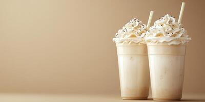 Delicious milkshakes topped with whipped cream and chocolate sprinkles on a neutral background photo