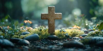 Cross surrounded by flowers and stones in a serene forest setting during golden hour photo