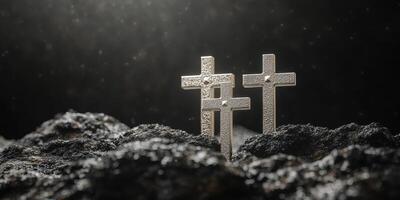 Reflective silver crosses shine in a dark and moody landscape with textured rocks photo