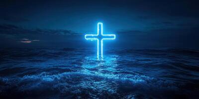 Neon cross illuminated in dark ocean waters at night creates a serene spiritual atmosphere photo