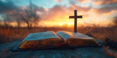 Beautiful sunset with an open Bible and cross in a serene outdoor setting at evening time photo