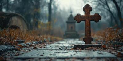 Artistic view of a weathered cross in a misty cemetery during autumn photo