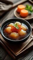Gourmet dessert featuring soft fruits topped with vibrant pearls served in a decorative bowl photo