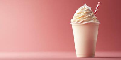 Creamy dessert treat served in a cup with a whimsical straw against a soft pink backdrop photo