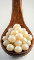 Flavorful pearls resting in a wooden spoon ready for cooking or garnishing dishes photo