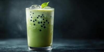Refreshing green drink with ice and mint served in a glass on a dark background photo