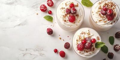 Delightful dessert cups topped with fresh raspberries and crunchy granola on a marble surface photo