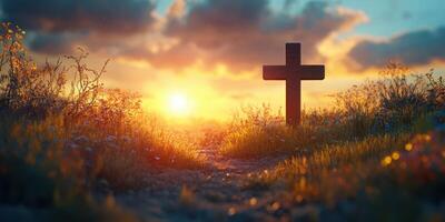Cross in a serene landscape at sunset with vibrant colors and flowers along the path photo