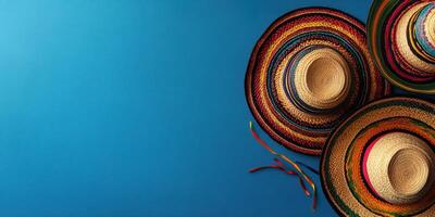 Colorful sombreros displayed against a vibrant blue background, showcasing traditional Mexican craftsmanship and design elements photo