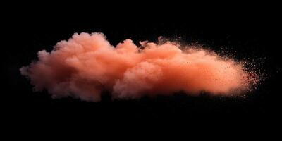 Colorful cloud of orange powder dispersing in the air against a black background photo