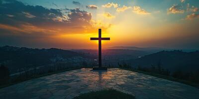Sunset view of a cross on a hilltop with vibrant clouds and a serene landscape in the background photo