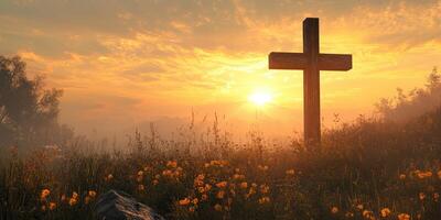 Cross stands peacefully in a vibrant sunset with blooming flowers in a tranquil field photo