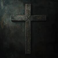 Black wooden cross against a dark background showcasing a simple yet profound religious symbol photo