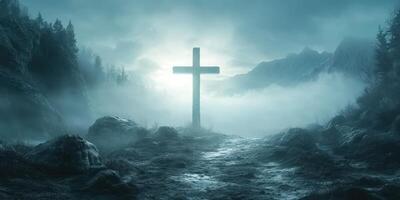 Mysterious landscape with a cross shrouded in mist at dusk near mountains photo