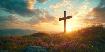 Sunset over a cross in a serene landscape with blooming flowers photo