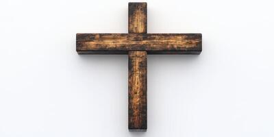 Wooden cross positioned against a simple white background symbolizes faith and spirituality in a serene manner photo