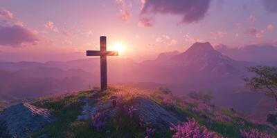 Sunset over a mountain landscape with a cross and blooming flowers in the foreground photo
