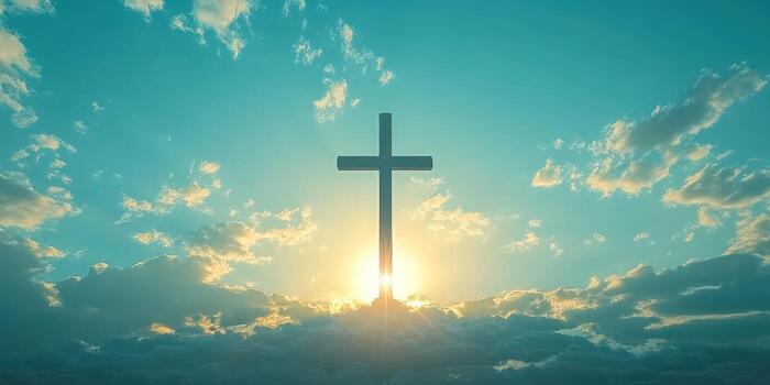 Sunrise illuminates a large cross against a vibrant sky with clouds in the background photo