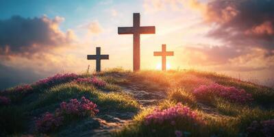 Sunrise over a hillside with three crosses surrounded by blooming flowers photo
