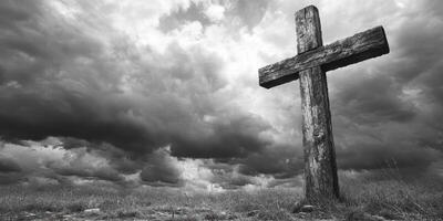 Wooden cross stands alone in a vast field under an ominous cloudy sky during the evening photo