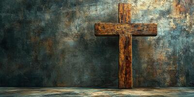 Rustic wooden cross displayed against a textured wall in a dimly lit setting photo