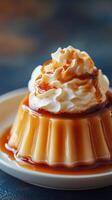 Delicious caramel flan topped with whipped cream on a plate photo