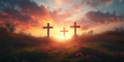 Sunset view of three crosses on a hillside surrounded by flowers and greenery photo
