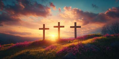Crosses silhouetted against a vibrant sunset near colorful flowers on a serene hillside photo