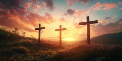 Sunset behind three wooden crosses on a hillside with vibrant clouds and glowing sky in the background photo
