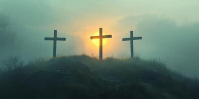 Crosses silhouetted against a misty sunrise in a serene natural setting photo