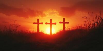 Three crosses silhouette against a vibrant sunset sky with clouds at dusk over a grassy hill photo