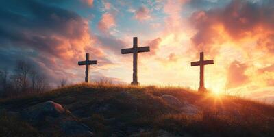 Three wooden crosses stand on a grassy hill at sunset, symbolizing peace and reflection in a serene landscape photo