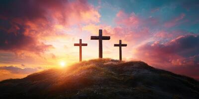 Three crosses stand on a hill at sunset with vibrant clouds showcasing a serene sky photo