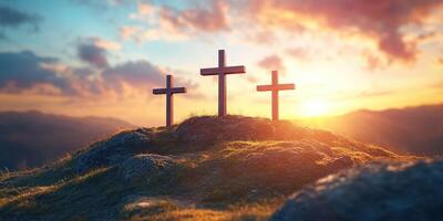 Three wooden crosses stand on a hilltop under a vibrant sunset sky in a serene landscape photo