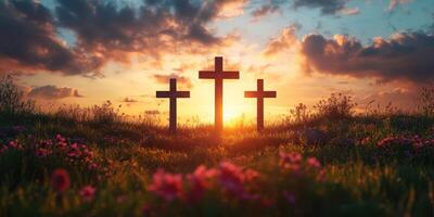 Sunset over three crosses in a serene landscape filled with flowers photo