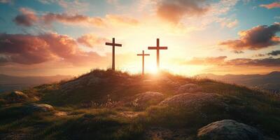 Sunrise over three crosses on a hill with clouds and mountains in background photo