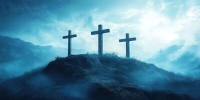 Three crosses stand atop a misty hill under a dramatic sky at dawn, symbolizing faith and redemption photo