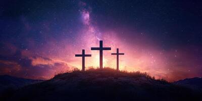 Three crosses silhouetted against a vibrant sunset sky with stars and clouds in a serene landscape photo