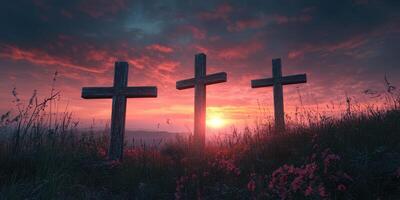 Three crosses stand against a vibrant sunset sky over a field of wildflowers in a serene landscape photo