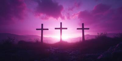 Three crosses stand on a hill at sunset, with purple skies illuminating the landscape in a serene moment of reflection photo