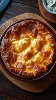 Savory baked dish with golden crust served on a wooden board in a cozy setting photo