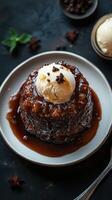 Delicious sticky toffee pudding with vanilla ice cream served on a plate photo